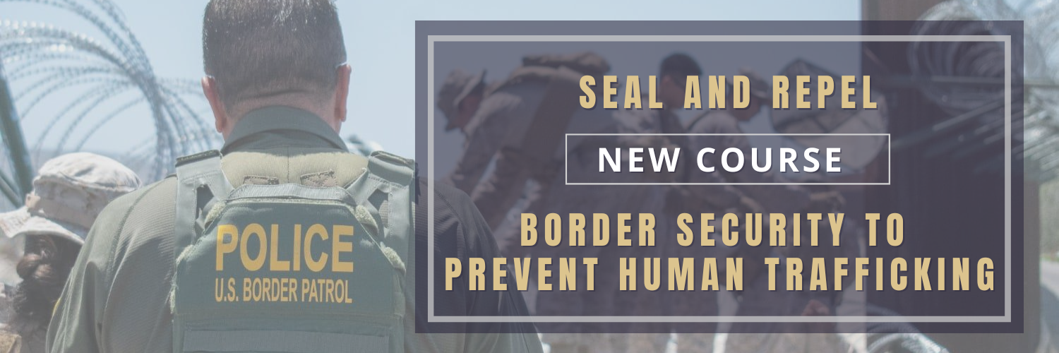 US Border patrol officers stand near a fence.